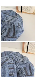 Close-up of vintage striped denim beret showing blue fabric texture and white stitching