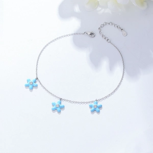 925 silver bohemian anklet with three light blue flowers and zircon stones on white background