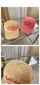 Detail of vintage corduroy baseball caps featuring intricate embroidery on khakis and pink colors