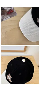 Detail of cute bear embroidery and corduroy texture on retro two-tone baseball cap