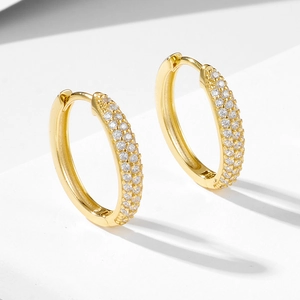 Macro shot of gold-plated silver hoop earrings with triple rows of pavé-set zircons