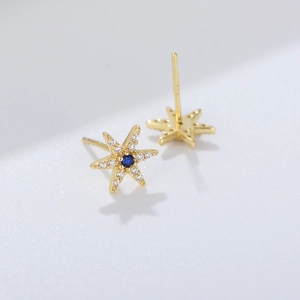 Close-up of S925 silver star stud earring with blue main stone and white diamond accents