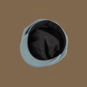Detail view of denim octagonal hat showing high-quality black lining and fine stitching