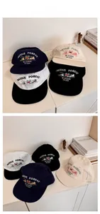 Flat lay display of four vintage embroidered baseball caps in navy, beige, and black