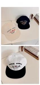 Flat lay of retro cotton baseball caps featuring Native Forest embroidery in various colors