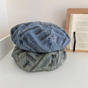 Retro denim beret with V-shaped stripe pattern in navy and light blue washes
