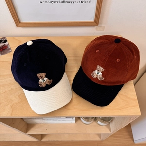 Vintage corduroy baseball caps with bear embroidery in navy and caramel colors