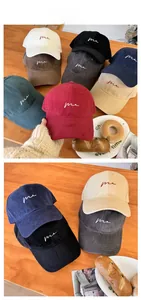 Detailed display of vintage baseball caps in various colors with minimalist me embroidery