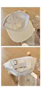 Detail view of the 100% cotton inner lining and adjustable metal buckle of the white cap