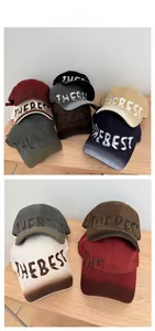 Tiled display of vintage washed cotton baseball caps with THE BEST graffiti embroidery