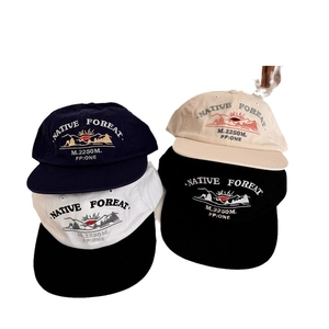 Stack of four cotton baseball caps with Native Forest embroidery in various colors
