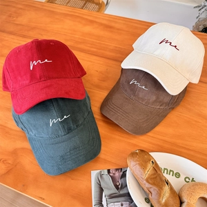 Classic cotton baseball caps in four colors featuring cursive 'me' embroidery on curved brims