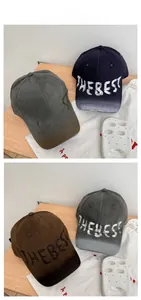 Macro shot of vintage washed baseball caps in four colors with THEBEST graphic embroidery