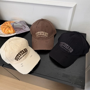 Vintage distressed baseball caps with Outstand embroidery in beige, brown and black
