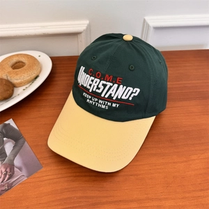 Contrast color baseball cap in dark green and beige with embroidered urban street style text