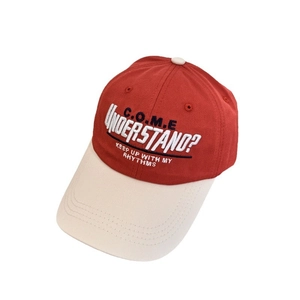 Two-tone contrast baseball cap with red crown and cream brim featuring 3D letter embroidery