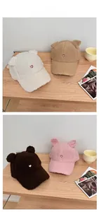 Detail of soft lamb wool baseball caps with cute bear ears and heart embroidery