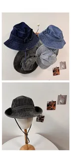 Detail of denim bucket hats with adjustable chin straps and multi-row brim stitching