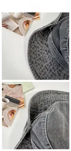 Detail of dark gray washed denim bucket hat with reinforced brim stitching texture