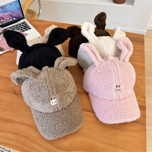 Cappellini da baseball con orecchie di coniglio in pile peluche in vari colori sul tavolo