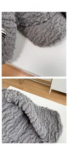 Gros plan sur tissu en laine d'agneau grise avec texture épaisse et étiquette tissée