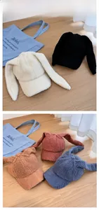 Flat lay display of cute lamb wool baseball caps with bunny ears in five soft colors
