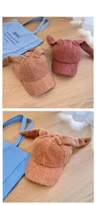 Detail of plush lamb wool baseball caps with cute bunny ears in khaki and pink