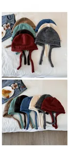 Detailed tile display of various knit earflap beanies with long straps in multiple colors