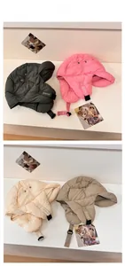 Quilted ear flap hat detail showing windproof fabric, adjustable buckle and four color options