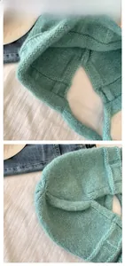 Macro detail of sky blue knitted ear protection hat with waffle weave and long straps
