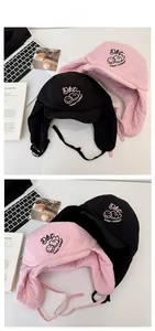 Quilted trapper hats in pink and black featuring sunflower embroidery and ear flaps