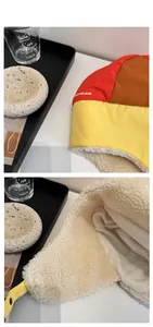 Detailed view of color-block winter trapper hat with warm white fleece lining and ear flaps