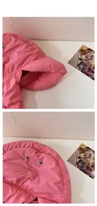 Detail of pink quilted thermal earflap hat featuring metal ventilation eyelets and thick padding