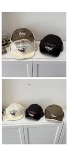Detailed tile display of winter earflap hats in beige, black and olive green with embroidery