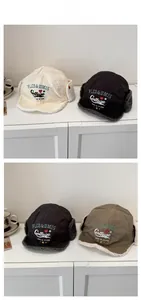 Detail of vintage trapper hats with warm fleece lining and college style embroidery