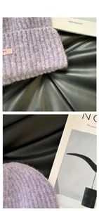 Detail of light purple knitted beanie featuring a pink leather patch and ribbed texture