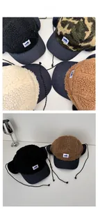 Detail view of fleece camouflage trapper hats with earflaps and adjustable drawstrings