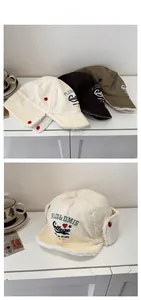 Detail of winter pilot hats with fleece lining and embroidered hearts in three colors