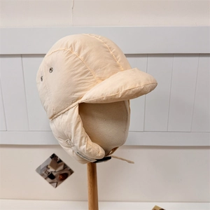 Beige lightweight quilted puffer trapper hat with windproof ear flaps and buckle strap