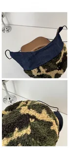 Detail of fleece camo trapper hat featuring denim visor and adjustable checkered drawstring