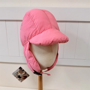 Pink windproof aviator hat with quilted texture and ear flaps for winter warmth