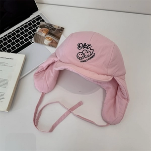 Pink quilted aviator hat with cartoon smiley face and earflaps for winter outdoor warmth