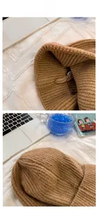 Detailed view of camel rib-knitted beanie showing texture and interior stitching