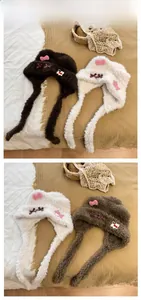 Detailed view of plush bear ear winter hats with pink bows in multiple cozy colors
