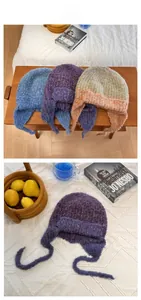 Detail view of colorful knit earflap hats with fuzzy mohair texture and long braided ties