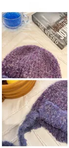 Detailed close-up of fluffy purple gradient knit beanie with cozy mohair texture