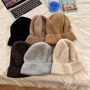 Knitted slouchy beanies in six neutral colors with ribbed texture and folded brim design