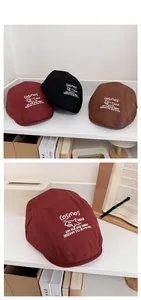 Detail of vintage flat caps with shark embroidery and Cosmos logo in three colors