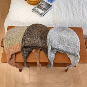Three gradient wool blend knitted ear-protection hats in orange, coffee, and grey colors