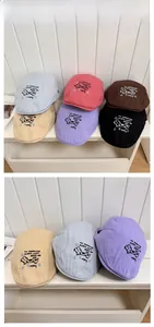 Detailed tile display of cotton newsboy hats featuring cartoon dog embroidery in six colors